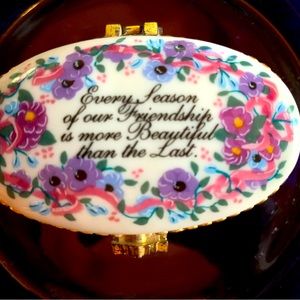 An oval porcelain flowered pill box. A perfect gift for your best fiend.
